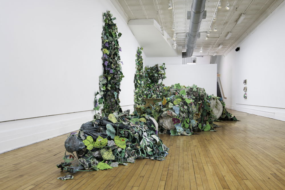 <em>Invasive Queer Kudzu: Richmond</em> by Aaron McIntosh, 2019. Mixed-media sculptural installation, event series, and public participation in which queer kudzu stories from Richmond and across the South are overtaking a felled Jefferson Davis monument. 1708 Gallery, Richmond, VA. Photo by Terry Brown.
