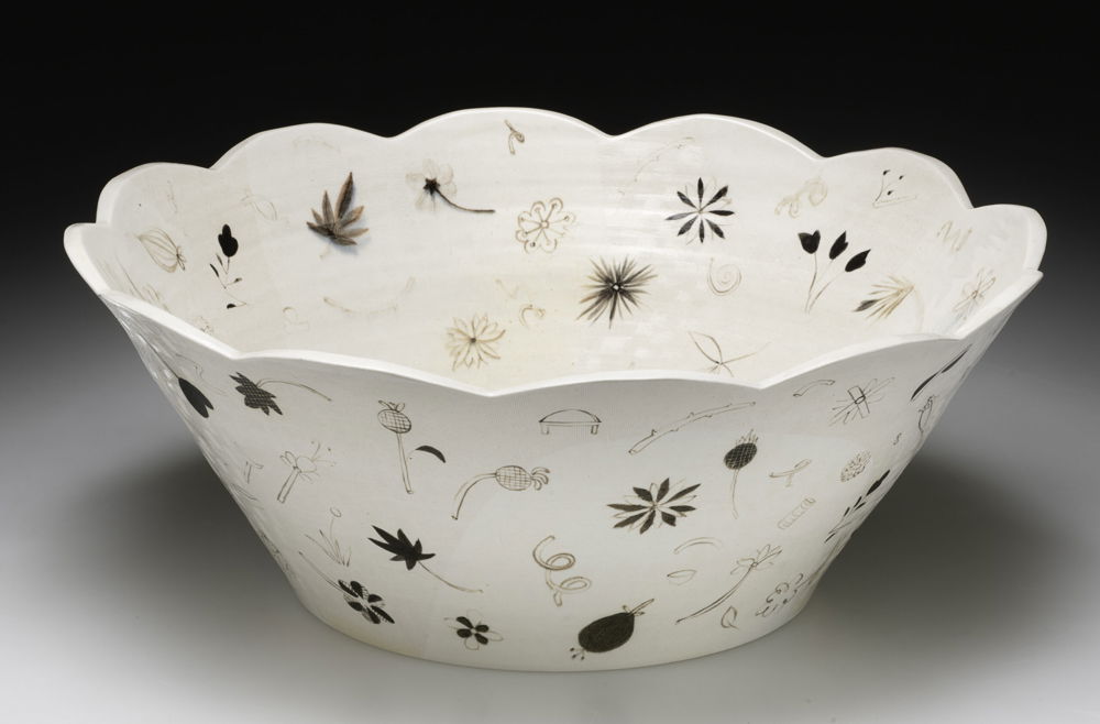 <em>Ground Constellation Bowl</em>, 2019. Porcelain, black slip, glaze, texture and salt fired, dimensions 7 × 18 × 18 inches. Large flat-bottomed ‘ground’ bowl with painted motifs of things found on the ground in the spring.