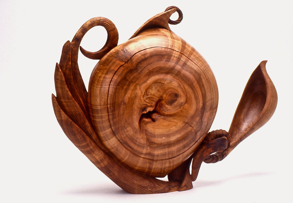 <em>Three Wishes Vase</em> by 2024, 1999. Turned and carved red maple burl with articulated spoon form, ring-pierced lip, 10 × 10 × 3 inches.