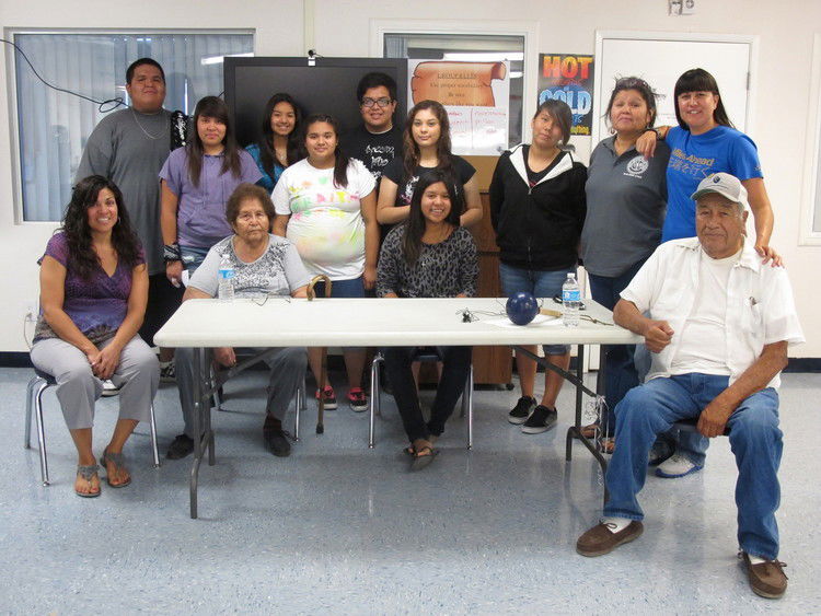 Photo of Natalie Diaz and a classroom full of people..