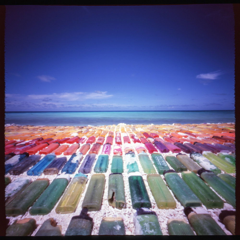 “Every Color Of The Rainbow” Onsite marine debris installation of found ‘disposable’ lighters. Pinhole photograph, 2016.