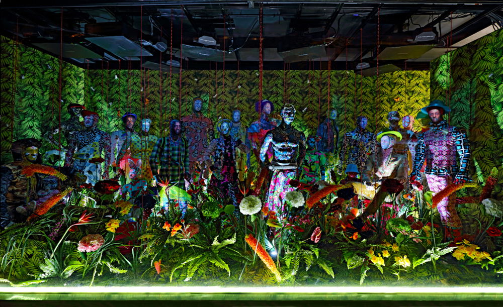 ...PRESENCE..., multi-media Installation with 23 embellished mannequins, 3D projection, sound with custom-made outfits, flowers, beads, accessories, shoes, plastic insects, feathered butterflies and cinderblocks, 2016-2017.