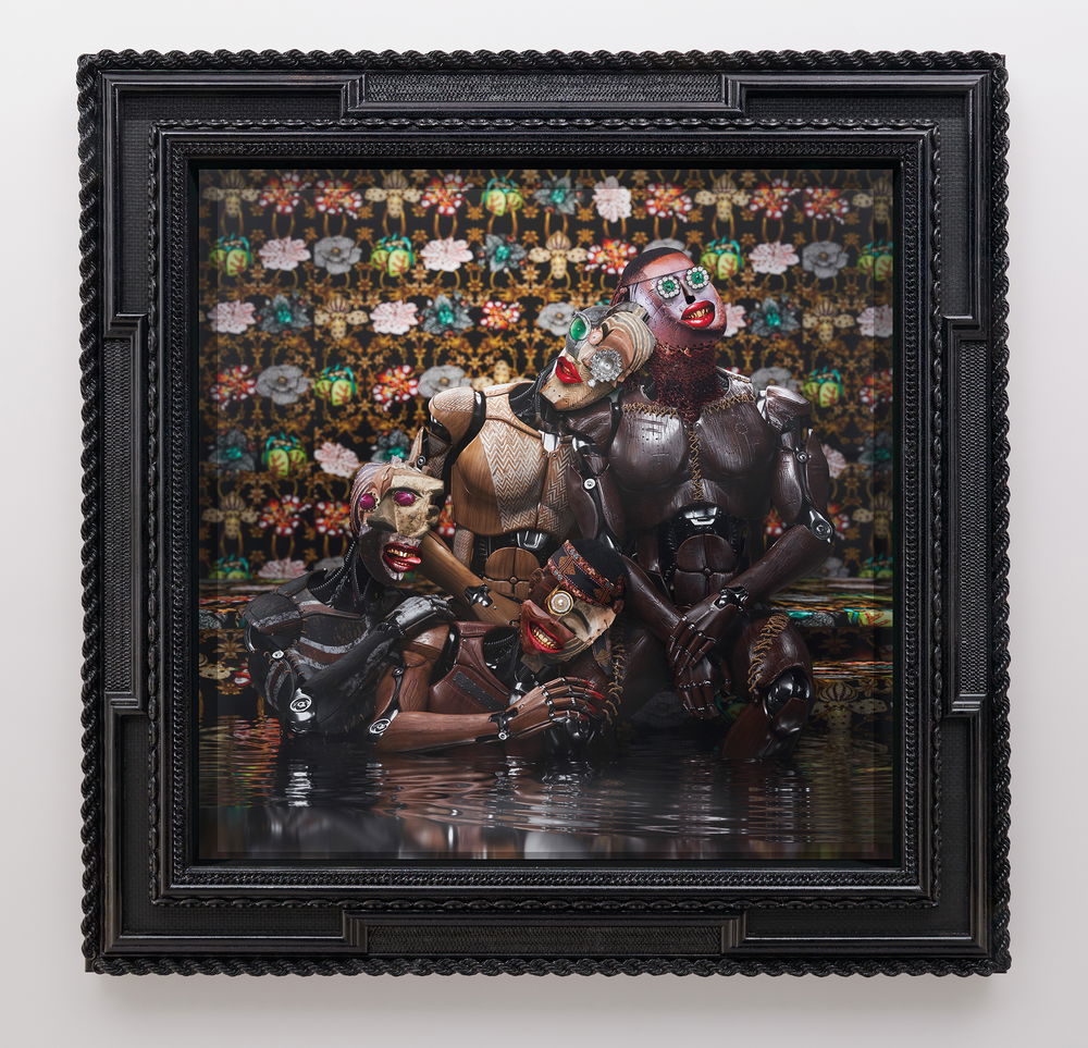 A multimedia collage featuring four cyborg figures posed in the style of a family portrait. A mom leans her collaged head on the dad's mannequin-like body while the two children smile and strike playful poses. The cyborg family stands in still black water. Behind them is floral-patterned wallpaper.