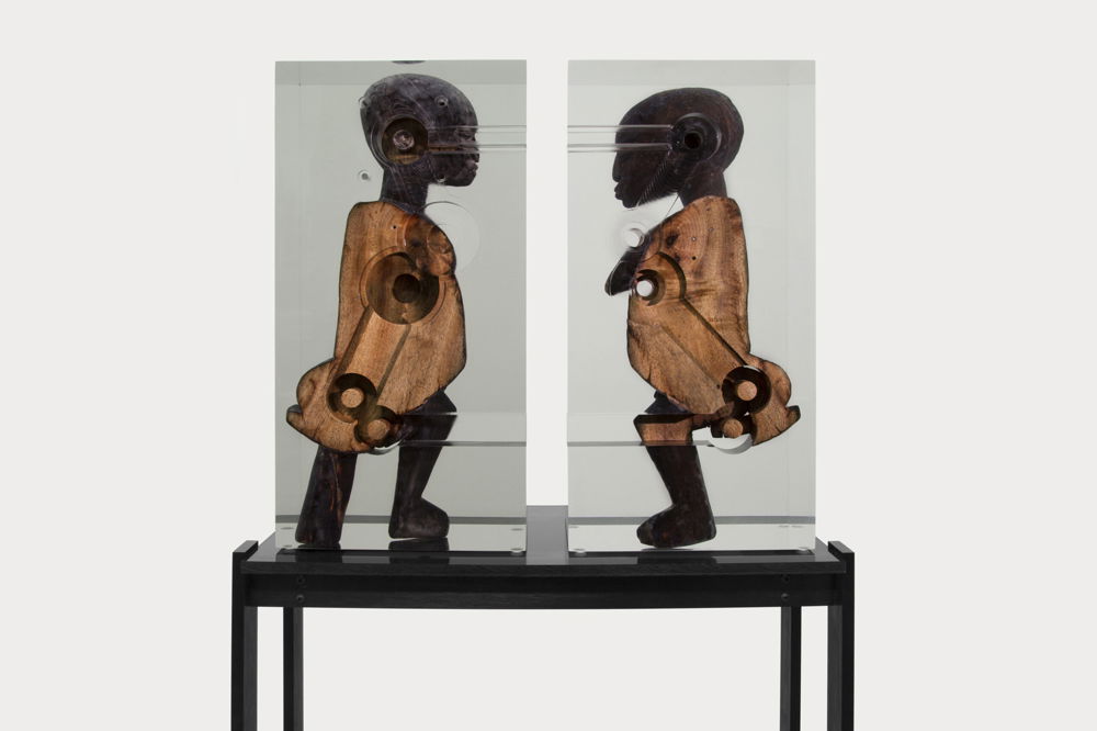 <em>Dark Silhouette: Couple Transfigured</em>, 2018. Wooden sculpture from West Africa, polyurethane resin, anodized aluminum, acrylic, dimensions 63.5 × 53.62 × 17.5 inches.
