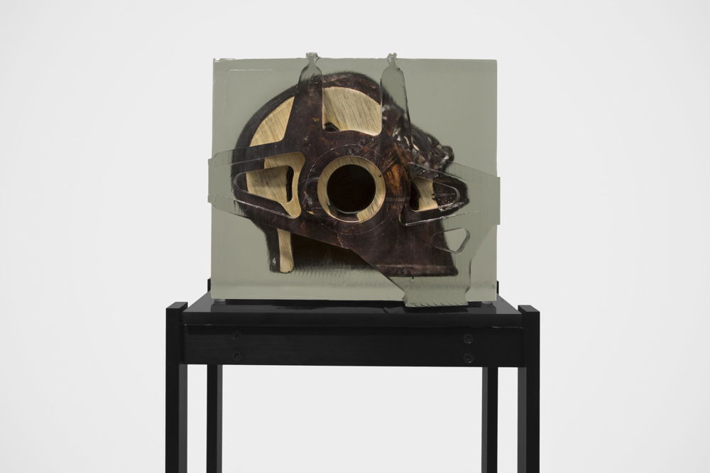 <em>Dark Silhouette: Angled Gaze</em> by Matthew Angelo Harrison, 2018. Wooden sculpture from West Africa, polyurethane resin, anodized aluminum, and acrylic, 50 × 13.75 × 9.25 inches.