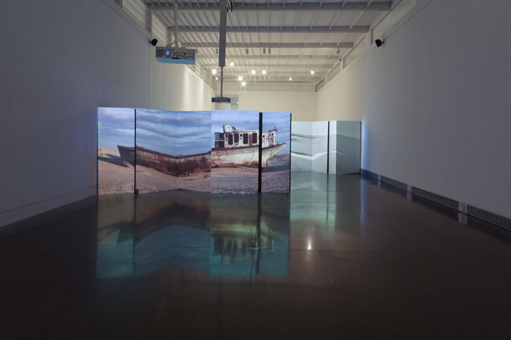 <em>Invocation For A Wandering Lake Part I & Il</em>, 2016. Projection on cardboard bifold panels, dimensions variable, Queens Museum, New York.