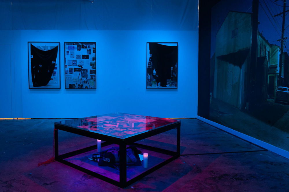 Installation shot of <em>Must've Been A Wake-dream</em>, a tryptic collaboration with artist Paul Sepuya at The Gordon Parks Foundation, 2019. Immersive space with archival material from the 1990s youth culture in Southern California, custom made steel and red plexiglass and glass go go boxes/platforms, photographs, flyers, clothing, magazines, perfumes.