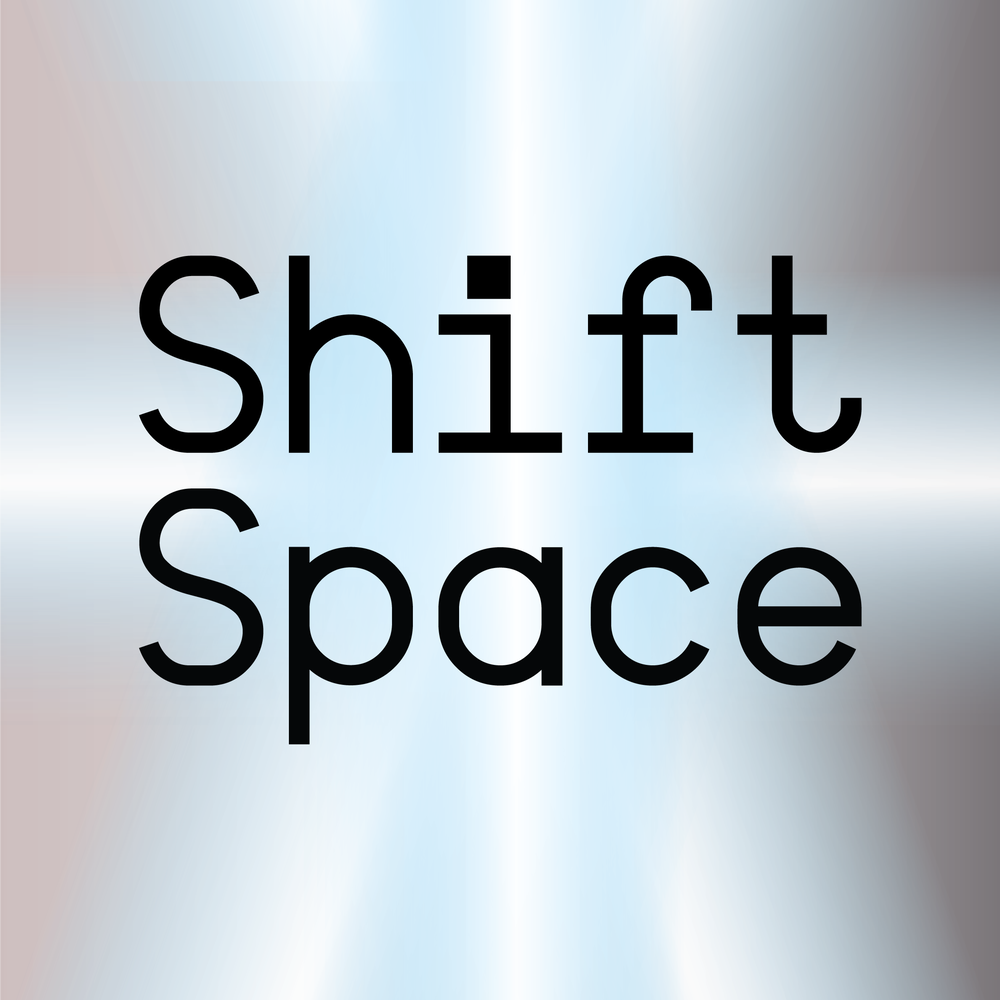 The words "Shift Space" in a black typewriter-style font on a gray background with a metallic sheen.