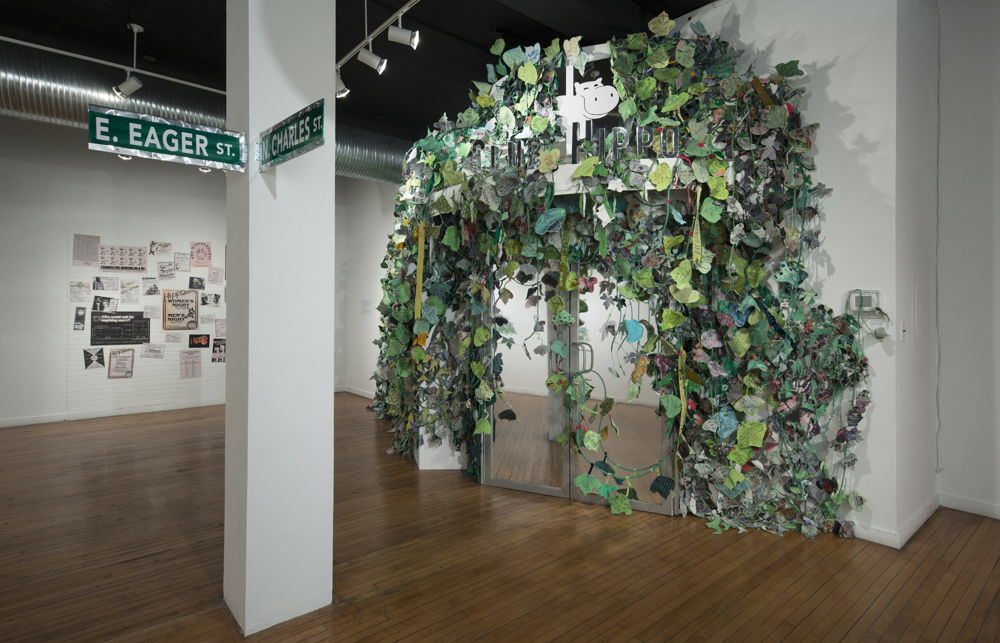 <em>Invasive Queer Kudzu: Baltimore</em> by Aaron McIntosh, 2018. Mixed-media sculptural installation, archive document wall, event series, and public participation in which queer kudzu stories from Richmond and across the South are overtaking a ghostly replica of the former historic Club Hippo queer nightclub. School 33 Arts Center, Baltimore, MD.